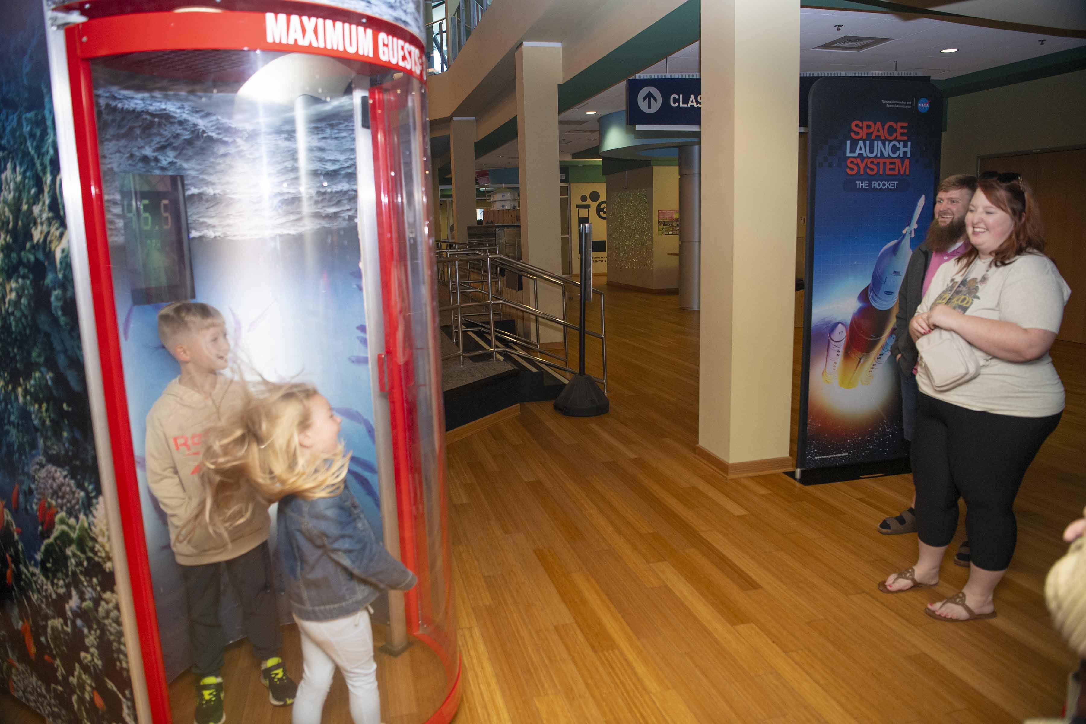 Young visitors enjoy the wind simulator at INFINITY Science Center.