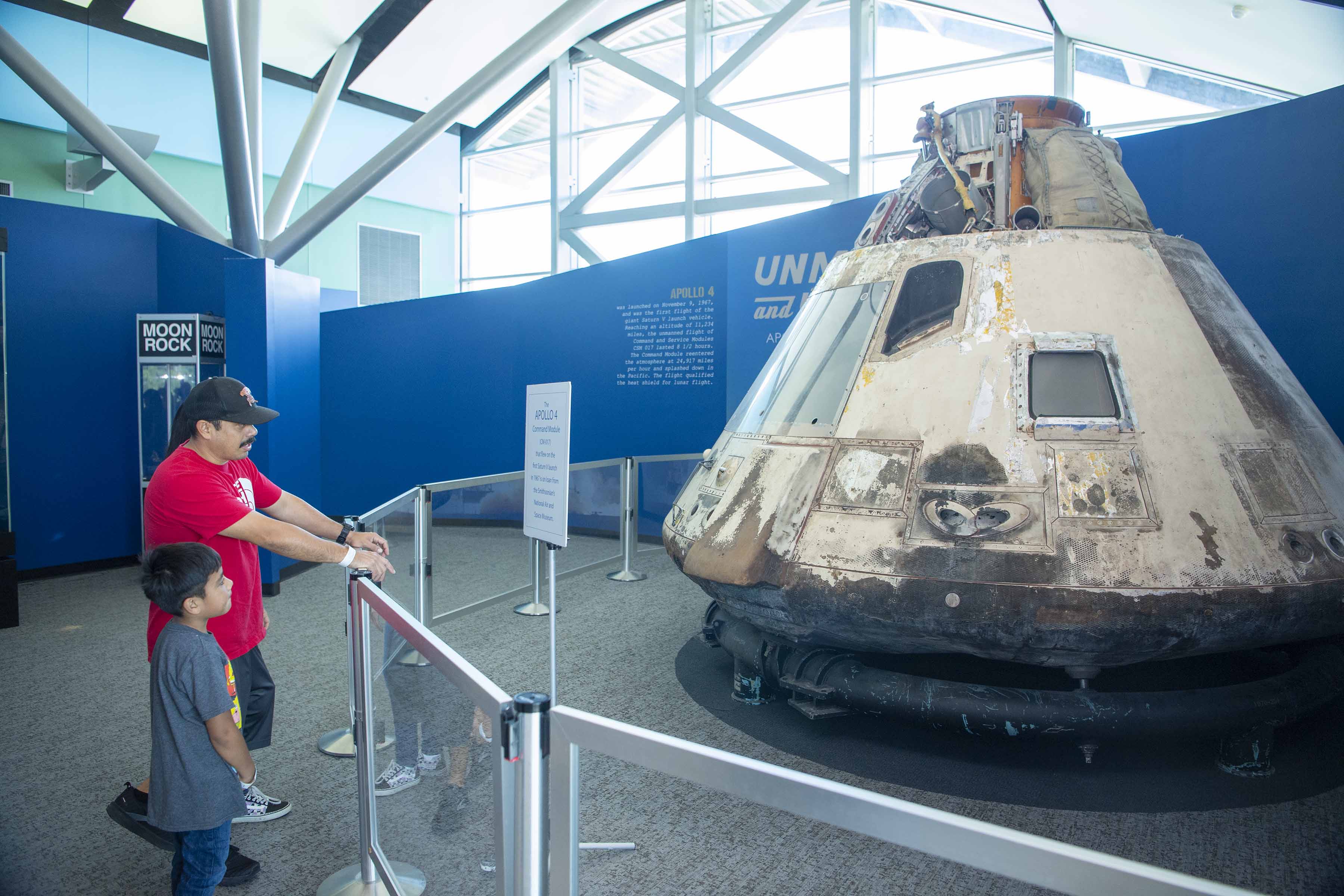 Visitors at INFINITY Science Center checkout the Apollo 4 exhibit
