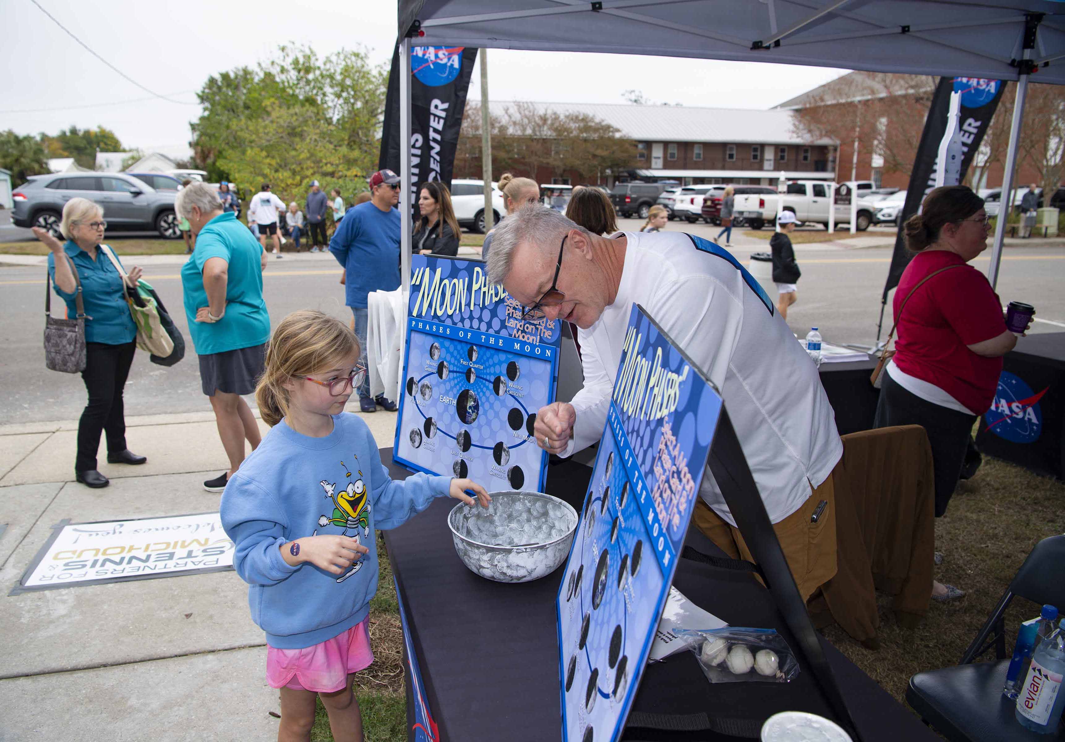 Young attendee learns about the phases of the moon at Stennis Day in the Bay