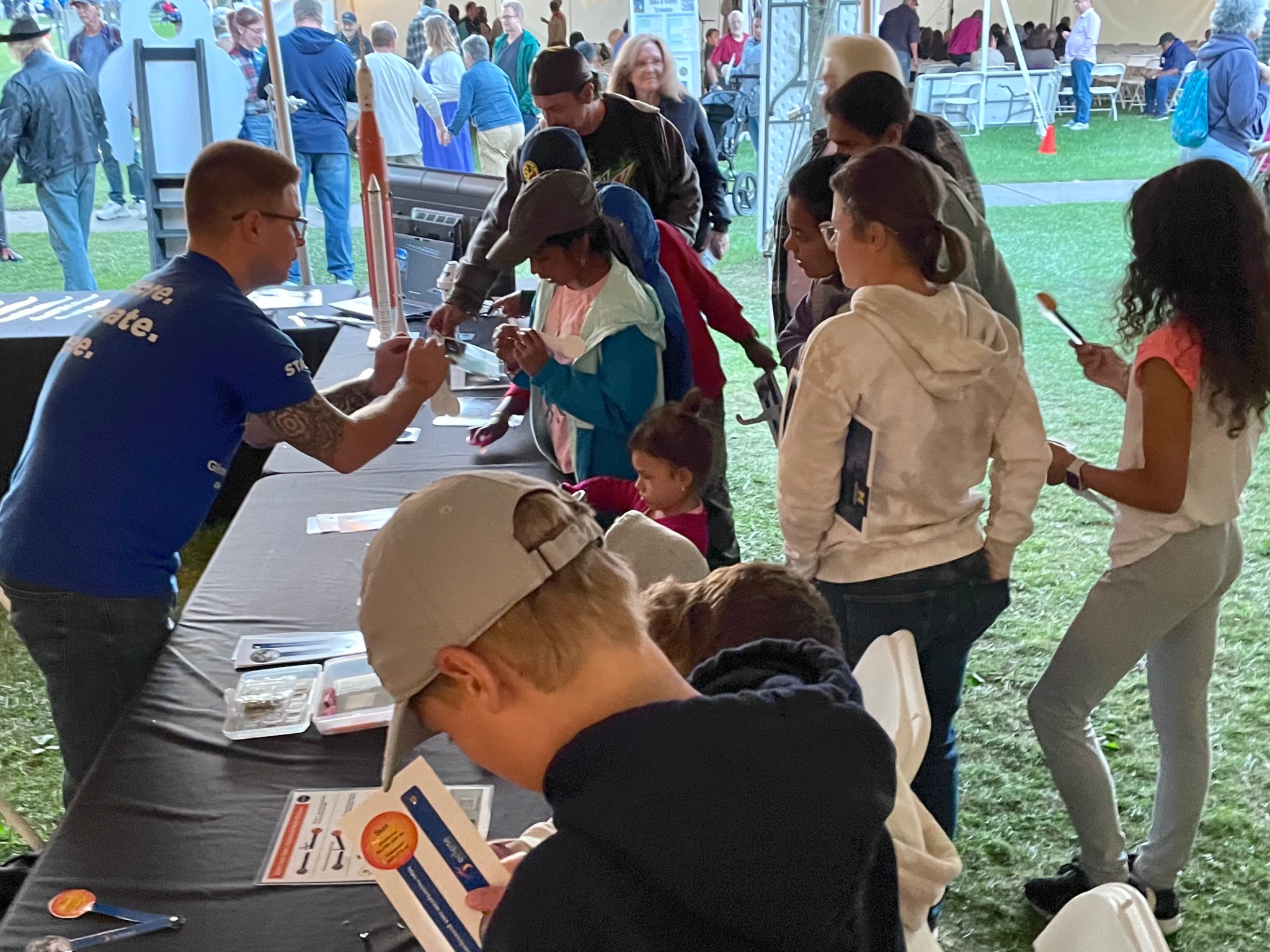 Matt Baeslack passes out kits for visitors to make a handheld solar eclipse.