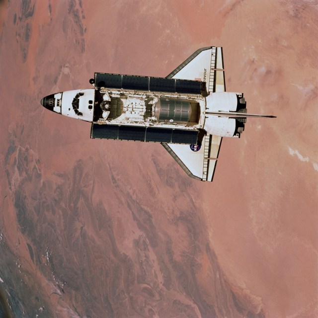 One of the three Expedition Two crew members aboard the International Space Station (ISS) captured this view of the Space Shuttle Endeavour with payload bay doors open as the Shuttle approached the orbital outpost for an April 21, 2001 docking. Raffaello, the second Multipurpose Logistics Module (MPLM) provided by the Italian Space Agency (ASI), can be seen in its berthed position in the cargo bay. Topography in northern Africa serves as a backdrop for the scene. Onboard the Station are cosmonaut Yury V. Usachev, Expedition Two commander, and astronauts Susan J. Helms and James S. Voss, flight engineers. Onboard the Shuttle are astronauts Kent V. Rominger, Jeffrey S. Ashby, Scott E. Parazynski, John L. Phillips, Chris A. Hadfield, and Umberto Guidoni, along with cosmonaut Yuri V. Lonchakov. Hadfield represents the Canadian Space Agency (CSA); Guidoni is with the European Space Agency (ESA) and Lonchakov is associated with Rosaviakosmos.