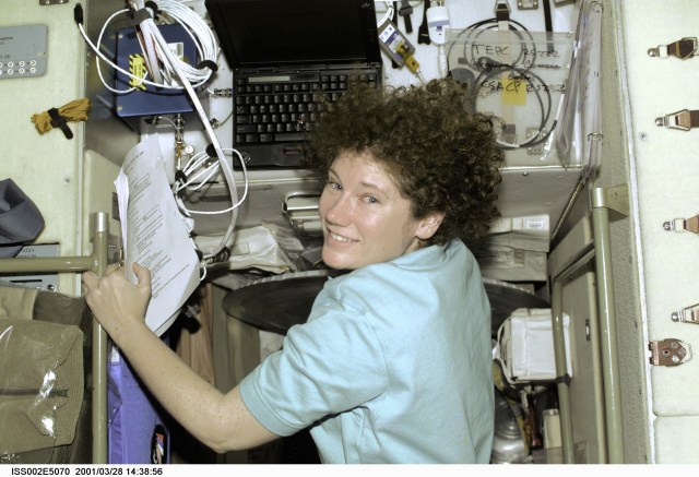Astronaut Susan J. Helms, Expedition Two flight engineer, checks over a printout while going about routine tasks in the Zvezda Service Module onboard the International Space Station (ISS). The photo was recorded with a digital still camera.
