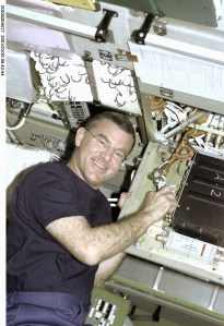 Astronaut James S. Voss, Expedition Two flight engineer, performs an electronics maintenance task in the Zvezda Service Module aboard the International Space Station (ISS). The photo was recorded with a digital still camera.