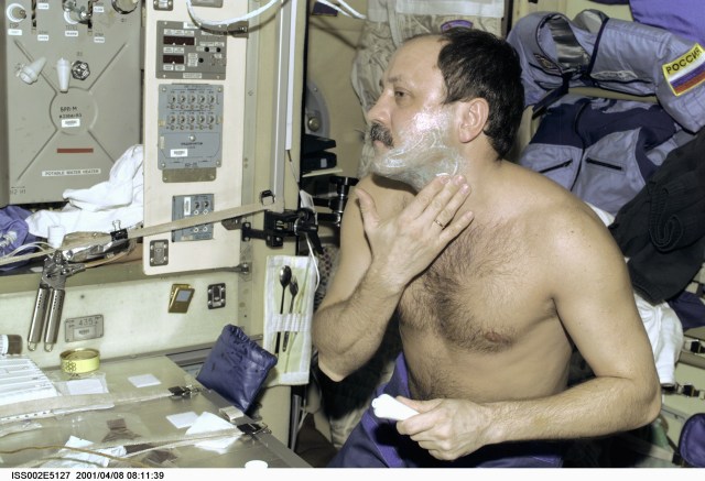 Cosmonaut Yury V. Usachev, Expedition Two mission commander, prepares to shave while in the Zvezda Service Module of the International Space Station (ISS). This image was recorded with a digital still camera.
