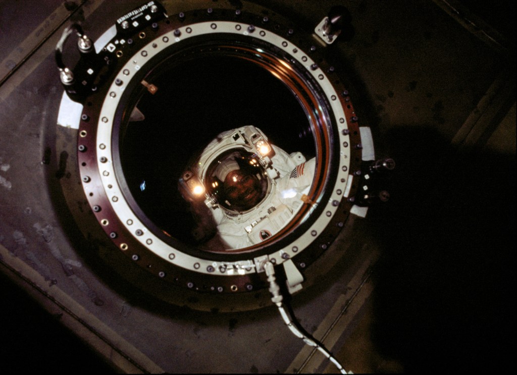 Astronaut Robert L. Curbeam, STS-98 mission specialist, was photographed by a member of the Expedition One crew in the newly installed Destiny laboratory during the second of three space walks. With all of the tasks planned for the second space walk completed, and still time available, the astronauts moved to tasks that had originally been planned for the third extravehicular activity (EVA) period on the flight. Ahead of schedule, they connected several computer and electrical cables between the docking port and the lab; unveiled the lab's large, high-quality window (through which this photo was taken) and attached an exterior shutter; and repositioned a movable foot platform they had taken inside Atlantis on the first spacewalk for a slight adjustment.