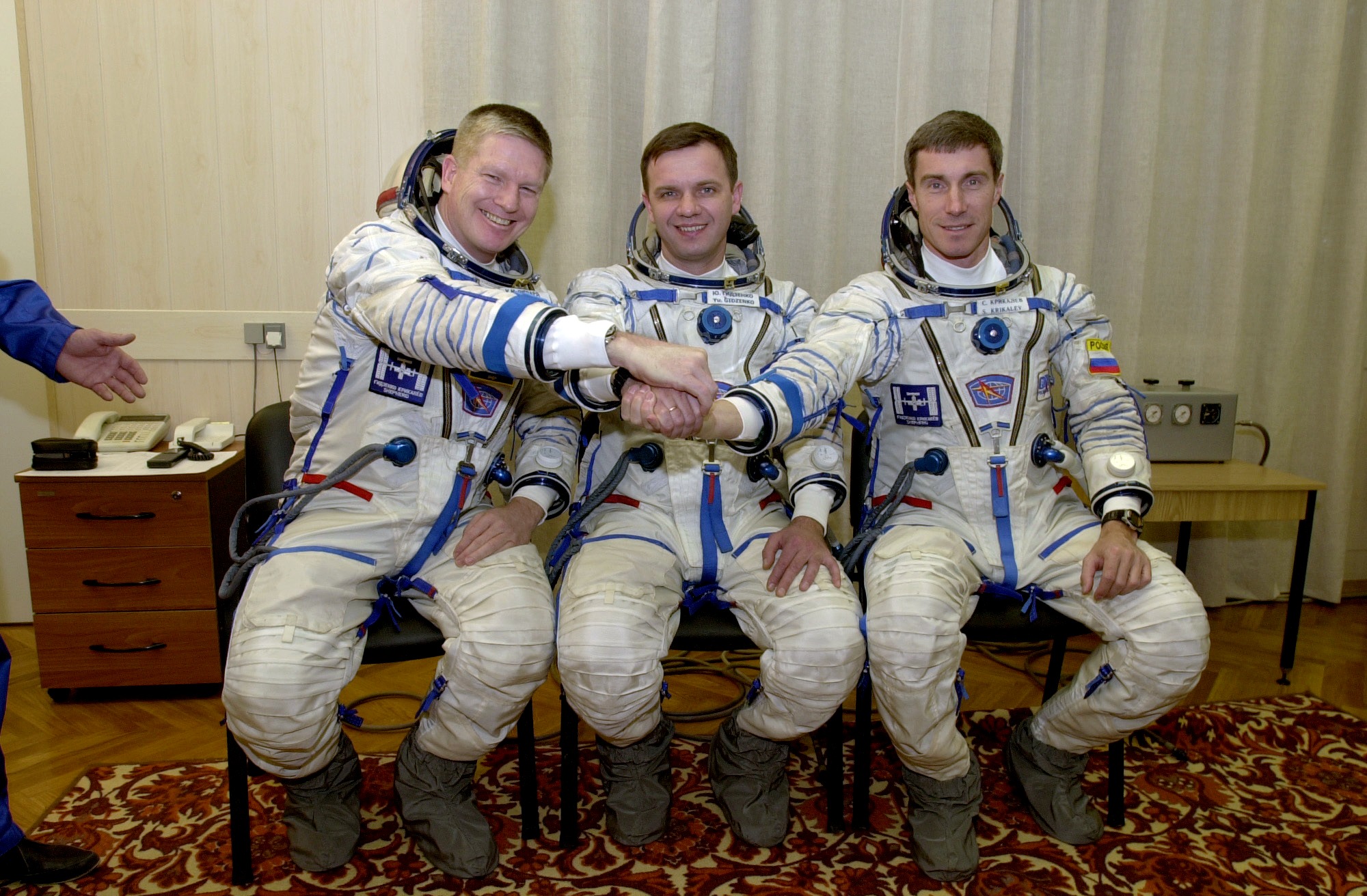 Joining hands during a break from training for their upcoming mission are, from the left, William M. Shepherd, Expedition 1 commander; Yuri P. Gidz...