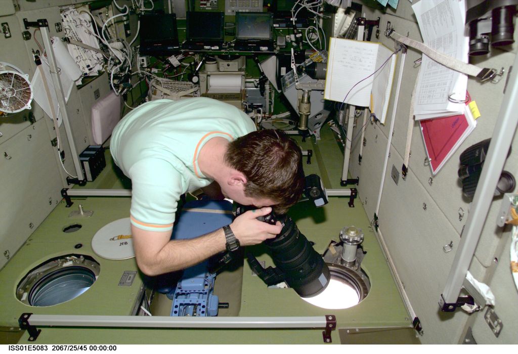 Cosmonaut Yuri P. Gidzenko, Expedition 1 Soyuz commander, takes a still photo of a geographic target of opportunity, through one of the viewing ports onboard the International Space Station's Zvezda Service Module.