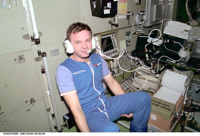 Cosmonaut Yuri P. Gidzenko, Soyuz commander for Expedition One, communicates with ground controllers onboard the Zvezda Service Module, one of the components of the Earth-orbiting Internation Space Station (ISS).