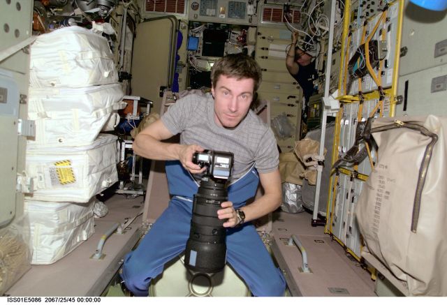 Cosmonaut Sergei K. Krikalev, Expedition 1 flight engineer, prepares to photograph some geographic targets of opportunity through a viewing port on the International Space Station's Zvezda Service Module.