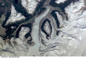 This nadir view of a Chilean glaciated area was provided by one of the early December digital still camera images down linked from the International Space Station (ISS) to ground controllers in Houston. The remote headwaters of the Rio de la Colonia are located on the eastern flank of the Cerro Pared Norte, a high, coastal range of the Andes in southern Chile. This is but a portion of a larger glaciated region of the Chilean coast located at only 47 degrees south latitude. The river actually begins its flow just off the top of this scene at the foot of the two large, converging, valley glaciers near the center. Some of the numerous lakes visible are tinted by the fine glacial sediments suspended in their waters. Note the shards of ice that have calved from the glaciers into the lakes on the left. Also note the shadows of the crest of the over 14,000-foot mountains (lower center). The remote headwaters of the Rio de la Colonia are located on the eastern flank of the Cerro Pared Norte, a high, coastal range of the Andes in southern Chile. This is a but a portion of a larger glaciated region of the Chilean coast located at only 47 degrees south latitude. The river actually begins its flow just off the top of this scene at the foot of the two large, converging, valley glaciers near the center. Some of the numerous lakes visible are tinted by the fine glacial sediments suspended in their waters. Note the shards of ice that have calved from the glaciers into the lakes on the left. Also note the shadows of the crest of the over 14,000-foot mountains (lower center).