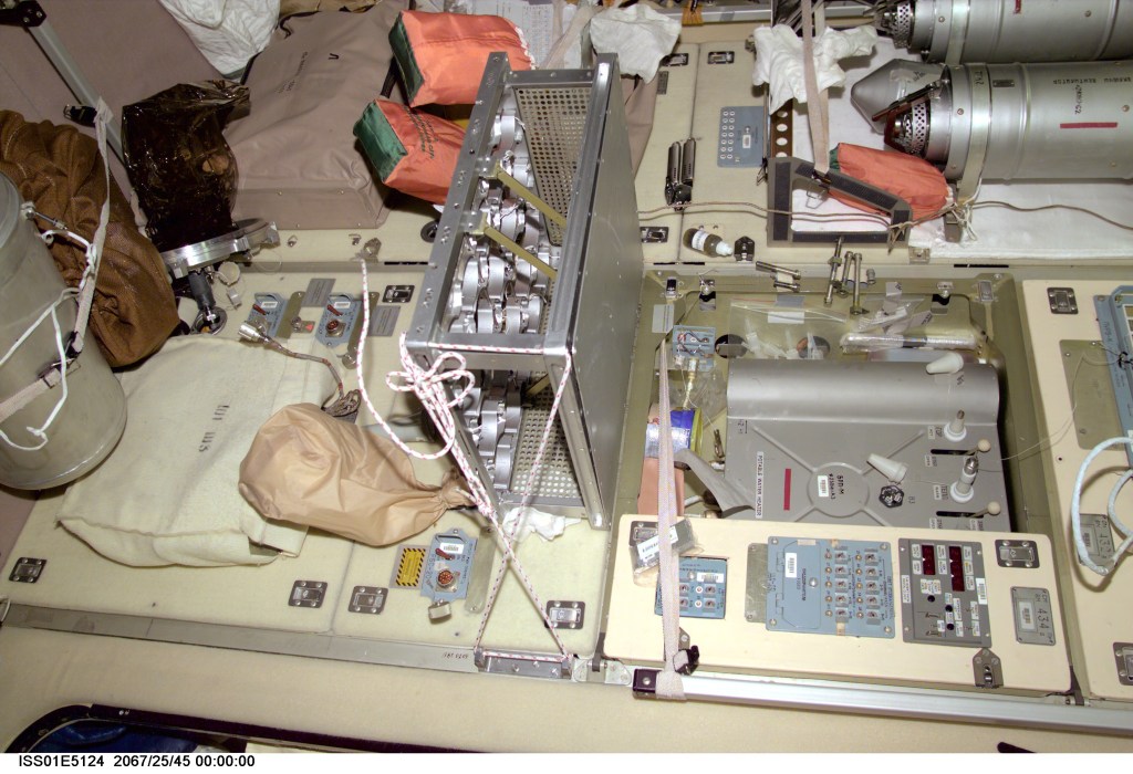 A medium closeup view, photographed with a digital still camera, shows part of the galley area on the International Space Station's Zvezda Service Module. The picture should be viewed vertically with potable water heater (right side of this frame) and distribution unit in the top half.