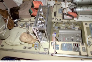A medium closeup view, photographed with a digital still camera, shows part of the galley area on the International Space Station's Zvezda Service Module. The picture should be viewed vertically with potable water heater (right side of this frame) and distribution unit in the top half.