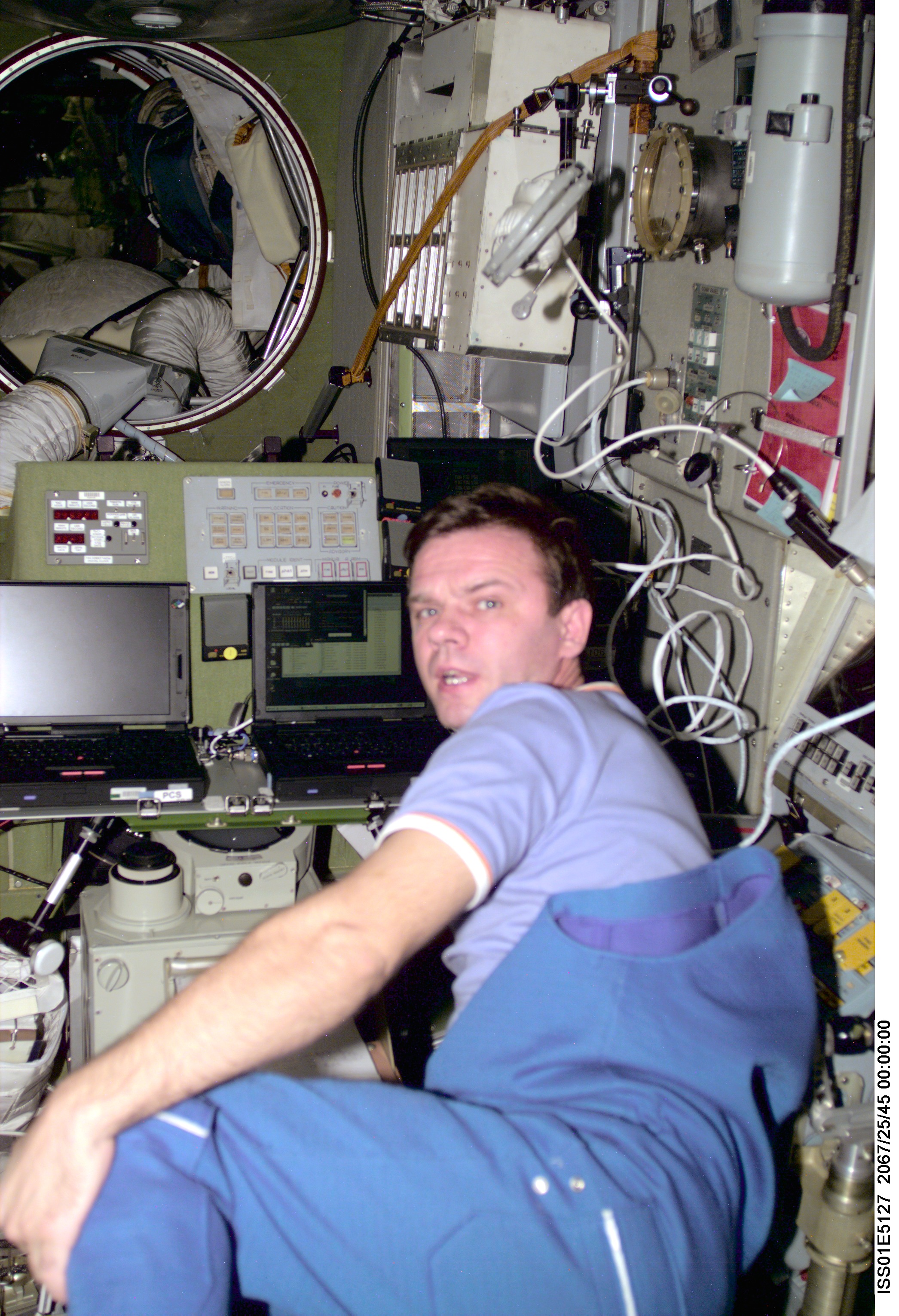 Cosmonaut Yuri P. Gidzenko, Soyuz commander for the Expedition One crew, works with some laptop computers in the Service Module's central post. The image was taken with a digital still camera and down linked from the station to ground controllers in Houston.