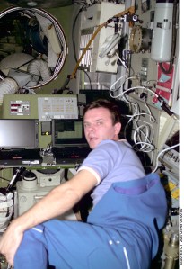 Cosmonaut Yuri P. Gidzenko, Soyuz commander for the Expedition One crew, works with some laptop computers in the Service Module's central post. The image was taken with a digital still camera and down linked from the station to ground controllers in Houston.