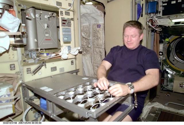 Astronaut William M. Shepherd, Expedition 1 commander, works on the food warmer for the Ward Room table aboard the station's Zvezda Service Module.