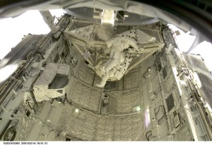 Astronauts Thomas D. Jones (partially obscured) and Robert L. Curbeam, STS-98 mission specialists, are pictured in the cargo bay of the Space Shuttle Atlantis during their third space walk, as photographed with a digital still camera from the International Space Station's new Destiny laboratory.