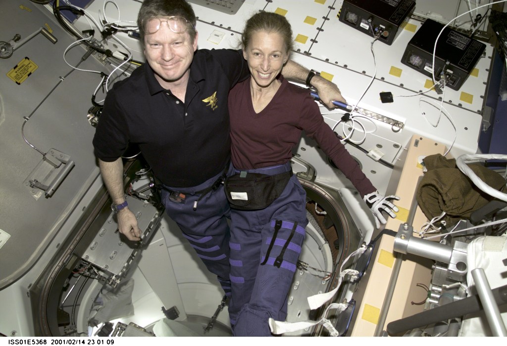 Onboard the new Destiny laboratory, Expedition One commander William M. (Bill) Shepherd, shares a brief break from a busy work agenda with astronaut Marsha S. Ivins, STS-98 mission specialist. The two are alumni of the tenth class of NASA astronaut candidates, having come aboard with 15 other trainees in the summer of 1984.