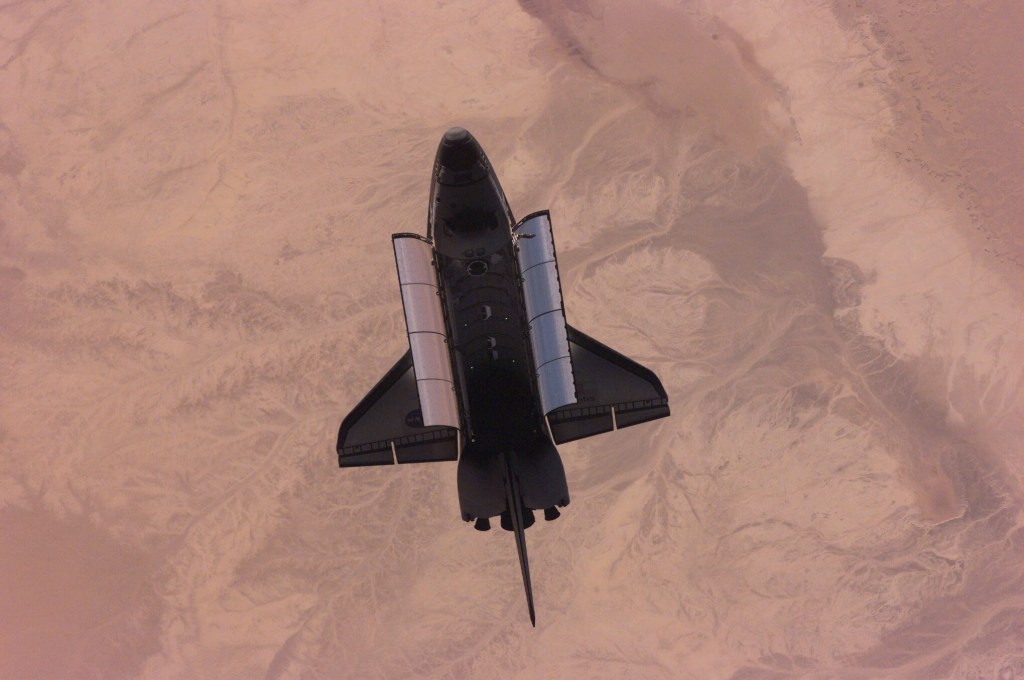 This nadir image of the Space Shuttle Atlantis backdropped over a desert was photographed by the three-man Expedition One crew aboard the International Space Station (ISS) shortly after the shuttle and the outpost unlinked following several days of joint operations of the two crews. The scene was recorded with a digital still camera.