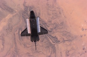 This high-angle image of the Space Shuttle Atlantis backdropped over a desert was photographed by the three-man Expedition One crew aboard the International Space Station (ISS) shortly after the shuttle and the outpost unlinked following several days of joint operations of the two crews. The scene was recorded with a digital still camera.
