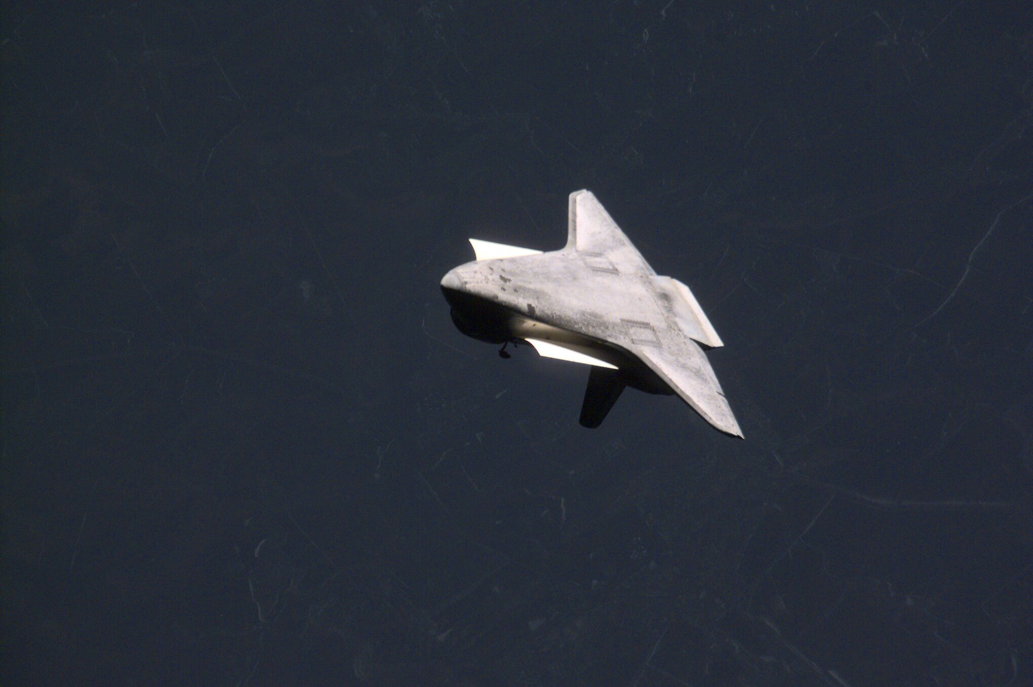 This rarely seen image of the underside of the Space Shuttle Atlantis was photographed by the three-man Expedition One crew aboard the International Space Station (ISS) after the shuttle and the outpost unlinked following several days of joint operations of the two crews. The scene was recorded with a digital still camera.