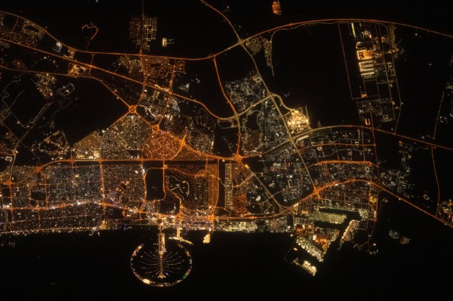 Palm Jumeirah, the palm tree-shaped artificial island, is a highlight in the United Arab Emirates' city of Dubai in this nighttime photograph from the International Space Station as it orbited 258 miles above the Persian Gulf.