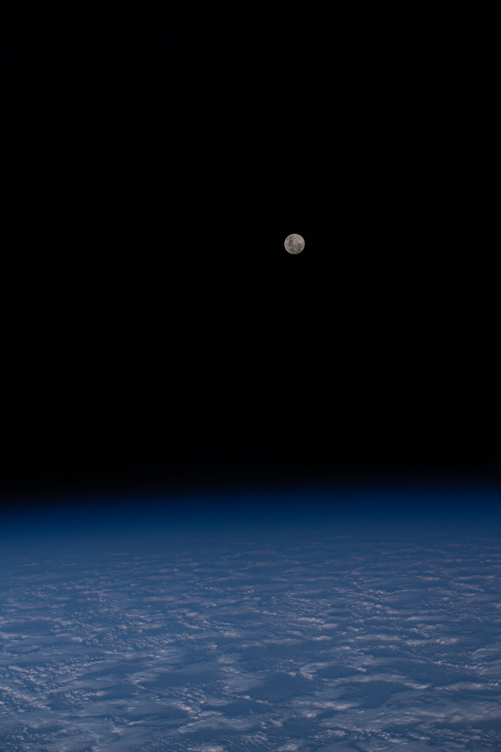 The Full Moon is pictured from the International Space Station as it orbited 271 miles above a cloudy south Indian Ocean half-way between Australia and Antarctica.