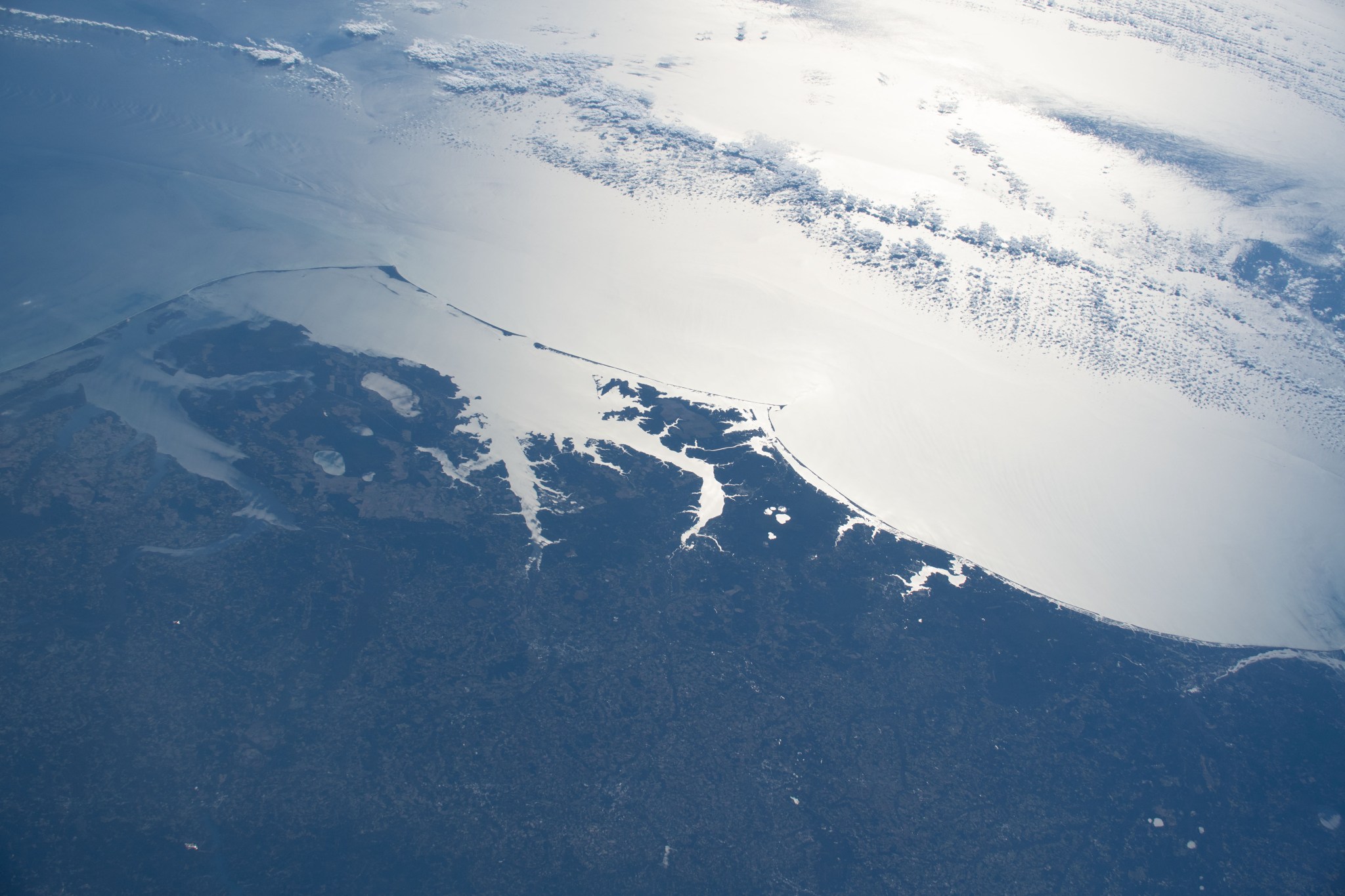 The gleaming Atlantic coast of North Carolina, from the cities of Kitty Hawk (far left) to Wilmington (far right), is pictured from the International Space Station as it orbited 261 miles above the eastern United States.