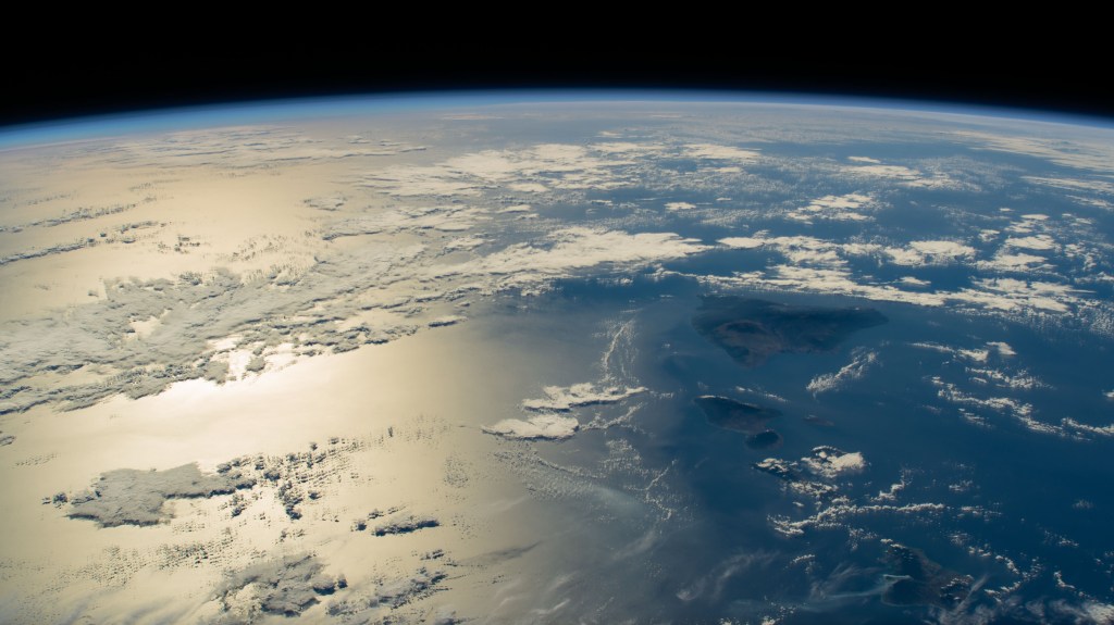 The sun's glint beams across the Pacific Ocean in this photograph from the International Space Station as it orbited 259 miles above the Hawaiian island chain.