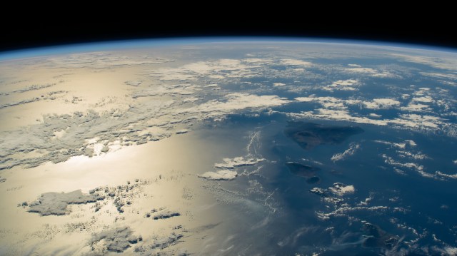 The sun's glint beams across the Pacific Ocean in this photograph from the International Space Station as it orbited 259 miles above the Hawaiian island chain.