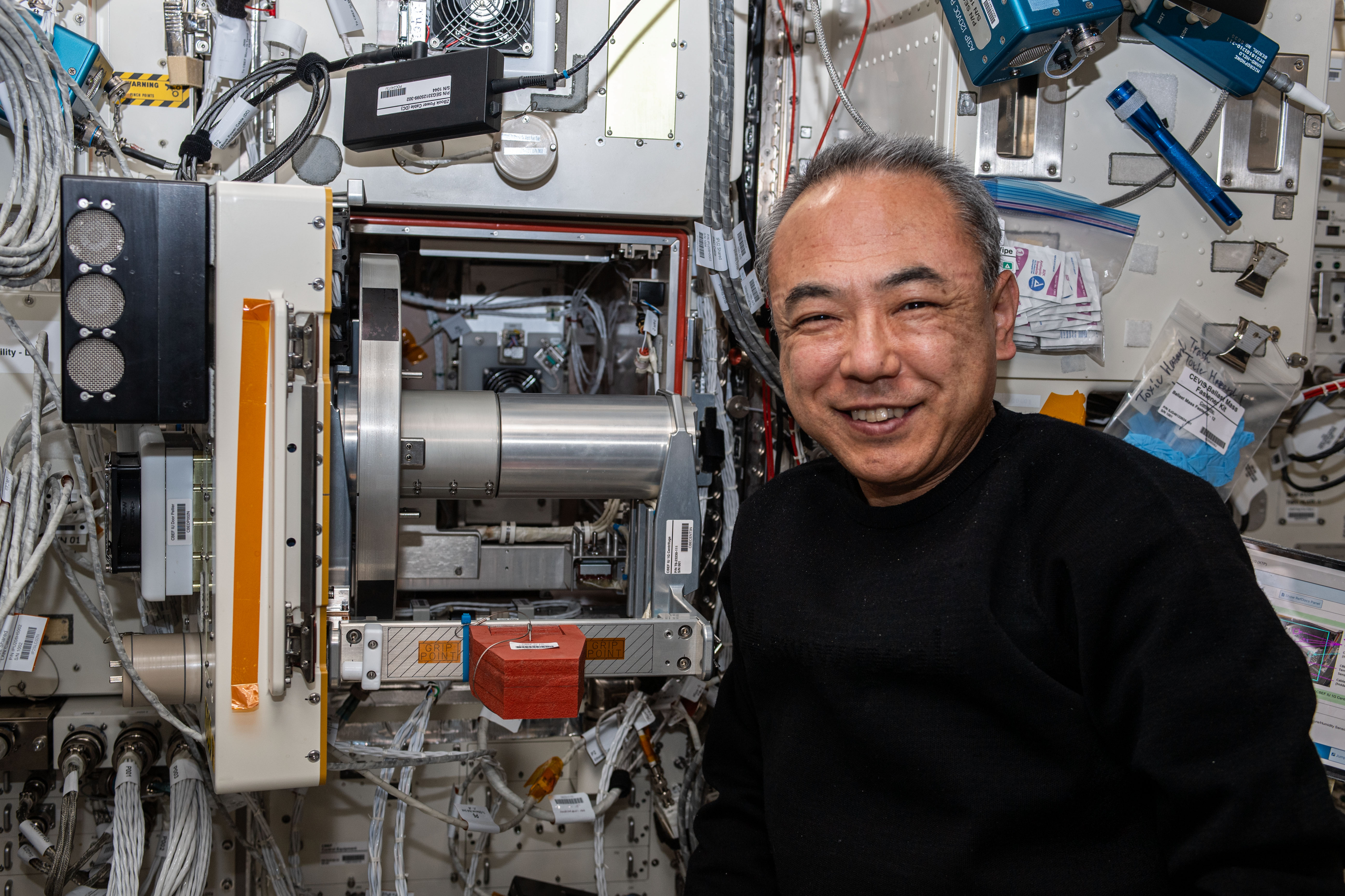 JAXA (Japan Aerospace Exploration Agency) astronaut and Expedition 70 Flight Engineer Satoshi Furukawa poses for a portrait next to the Cell Biology Experiment Facility Incubator Unit inside the International Space Station's Kibo laboratory module.