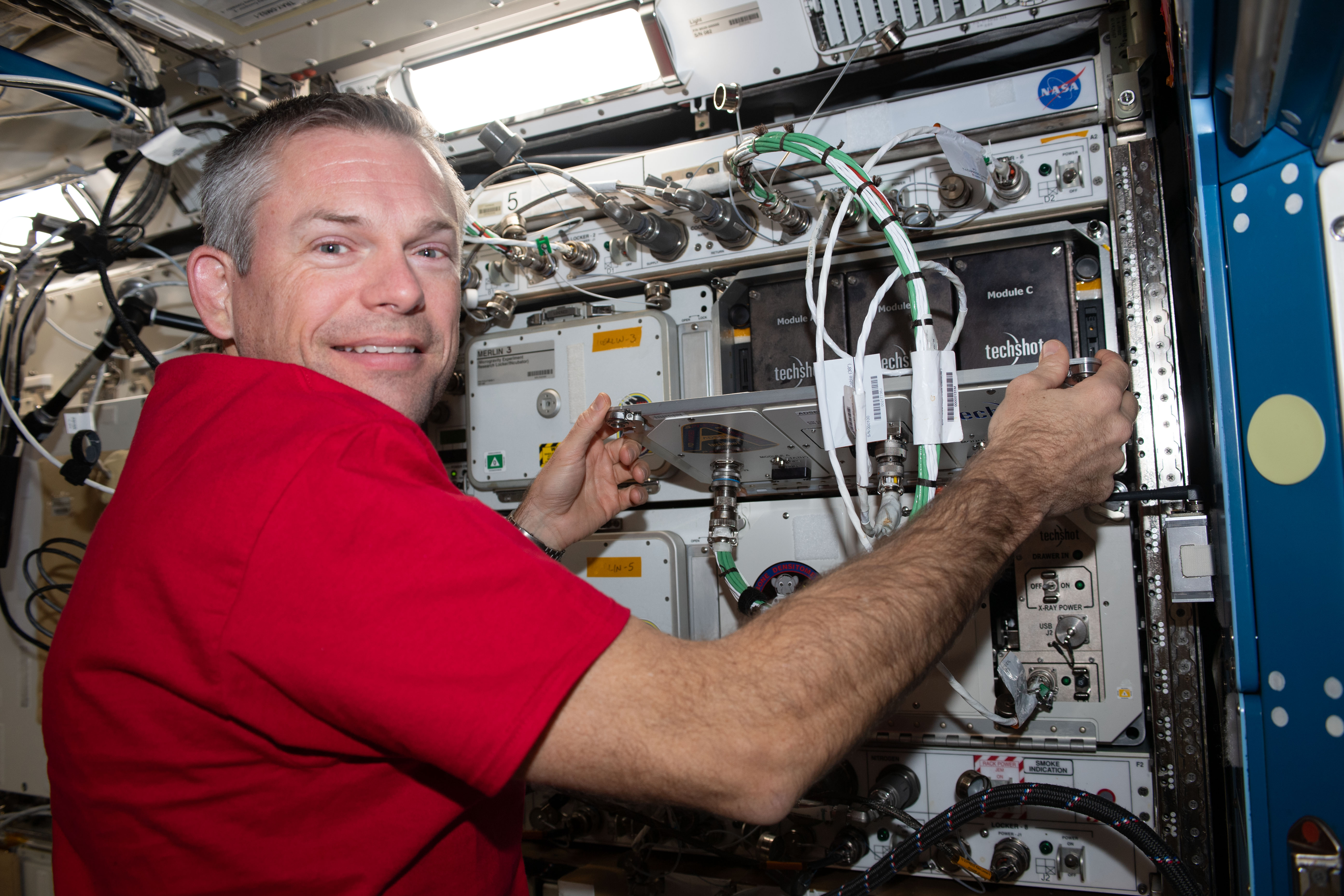 ESA (European Space Agency) astronaut and Expedition 70 Commander Andreas Mogensen replaces computer hardware inside the Advanced Space Experiment Processor-2 (ADSEP-2) that can house and process samples for a variety of biological and physical science experiments.