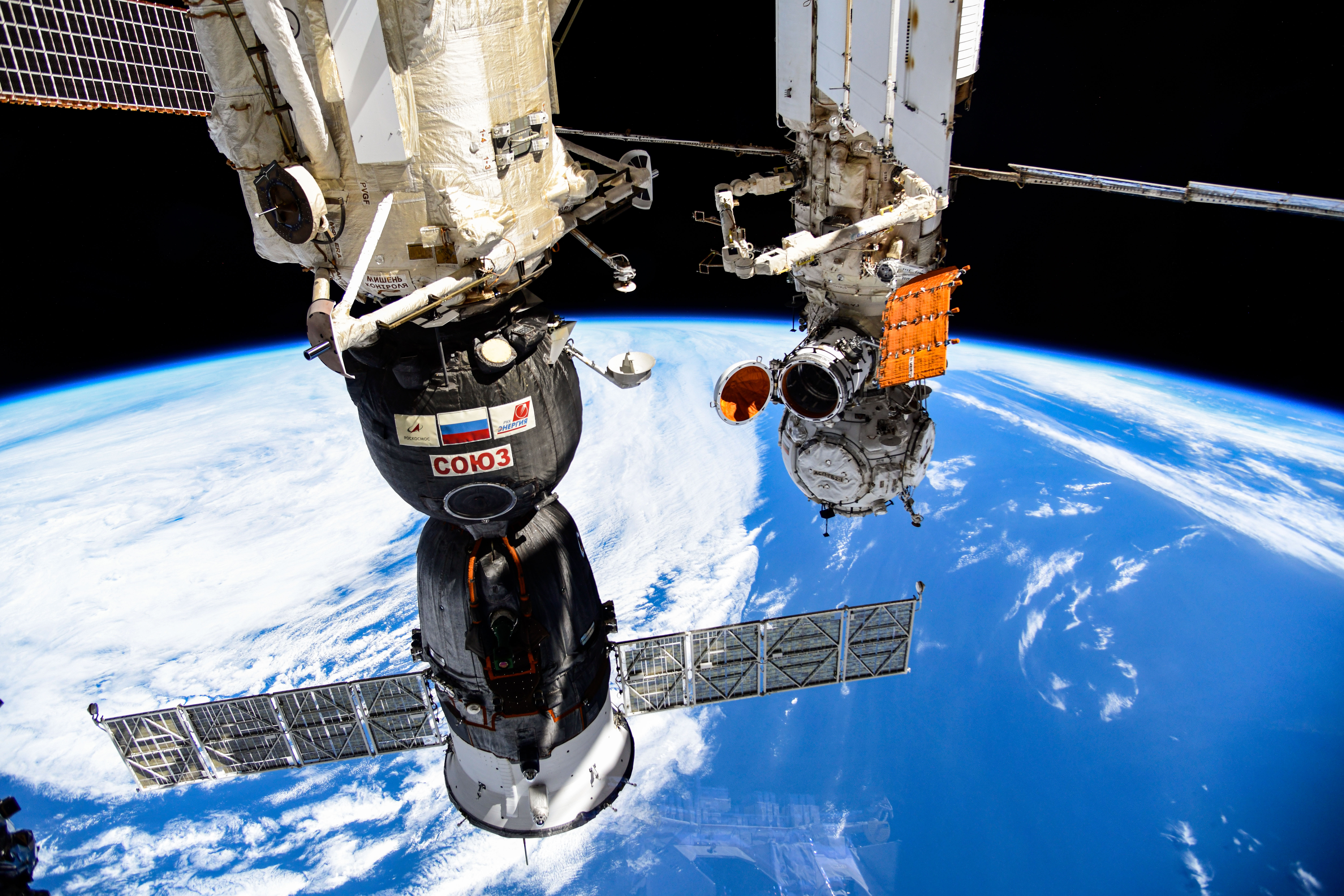 iss070e024780 (Nov. 14, 2023) --- The Soyuz MS-24 spacecraft (foreground) that carried NASA astronaut Loral O'Hara and Roscosmos cosmonauts Oleg Kononenko and Nikolai Chub to the International Space Station is pictured docked to the Rassvet module. In the rear, is the Prichal docking module and the Nauka science module with its experiment airlock door opened to the external microgravity environment. Credit: Roscosmos