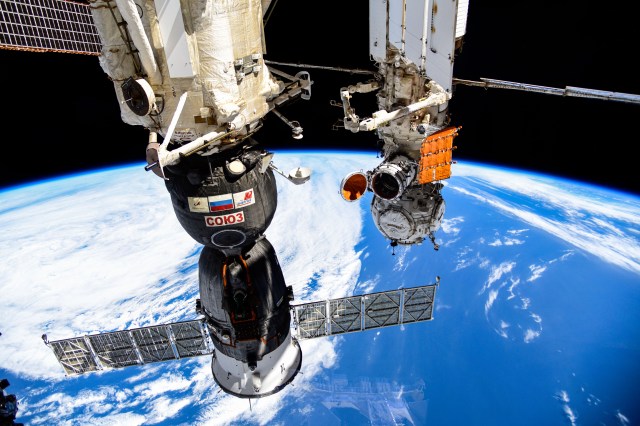 iss070e024780 (Nov. 14, 2023) --- The Soyuz MS-24 spacecraft (foreground) that carried NASA astronaut Loral O'Hara and Roscosmos cosmonauts Oleg Kononenko and Nikolai Chub to the International Space Station is pictured docked to the Rassvet module. In the rear, is the Prichal docking module and the Nauka science module with its experiment airlock door opened to the external microgravity environment. Credit: Roscosmos