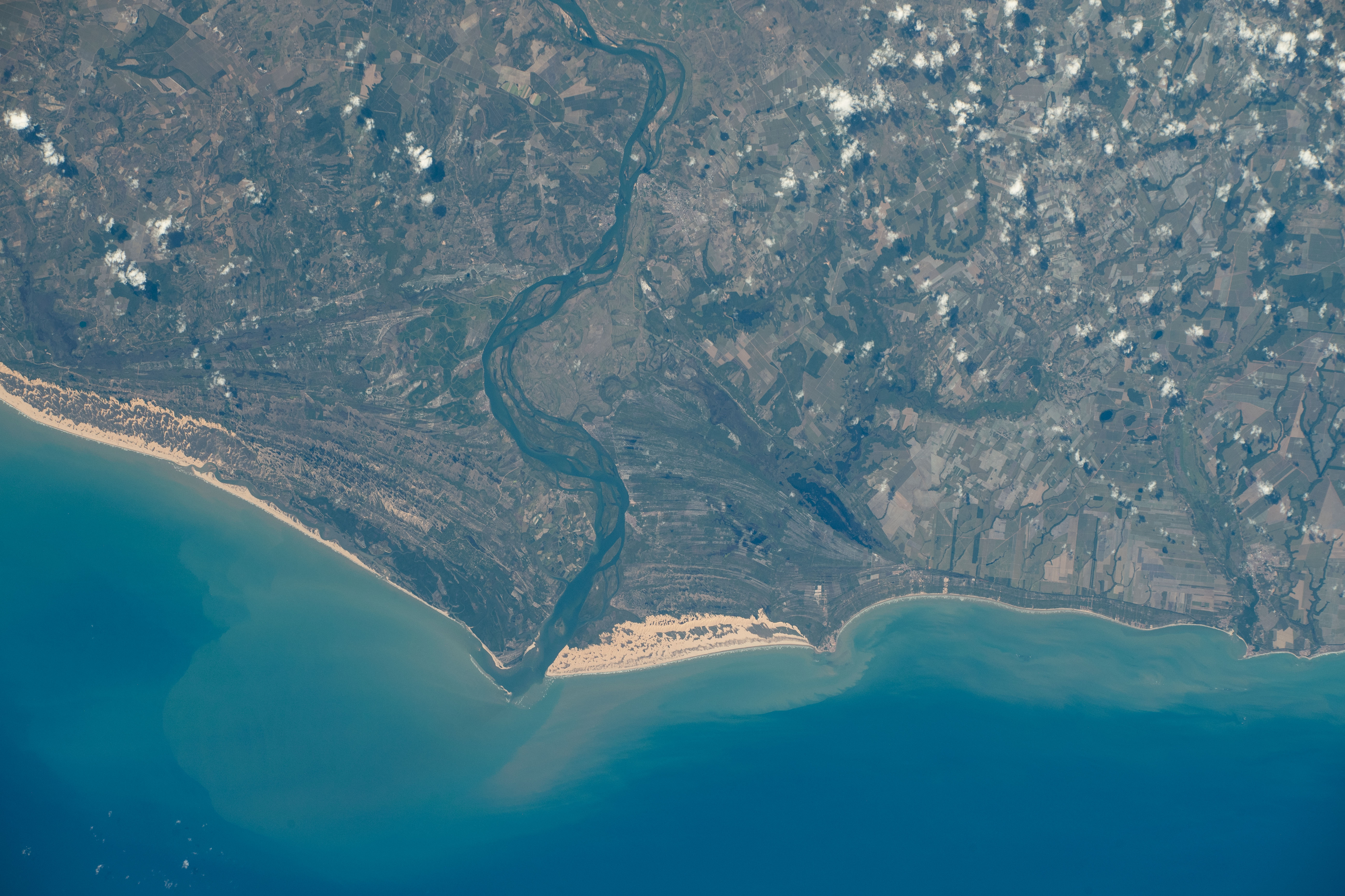 The São Francisco River empties into the Atlantic Ocean and splits the Brazilian states of Sergipe and Alagoas in this photograph from the International Space Station as it orbited 262 miles above the South American coast.