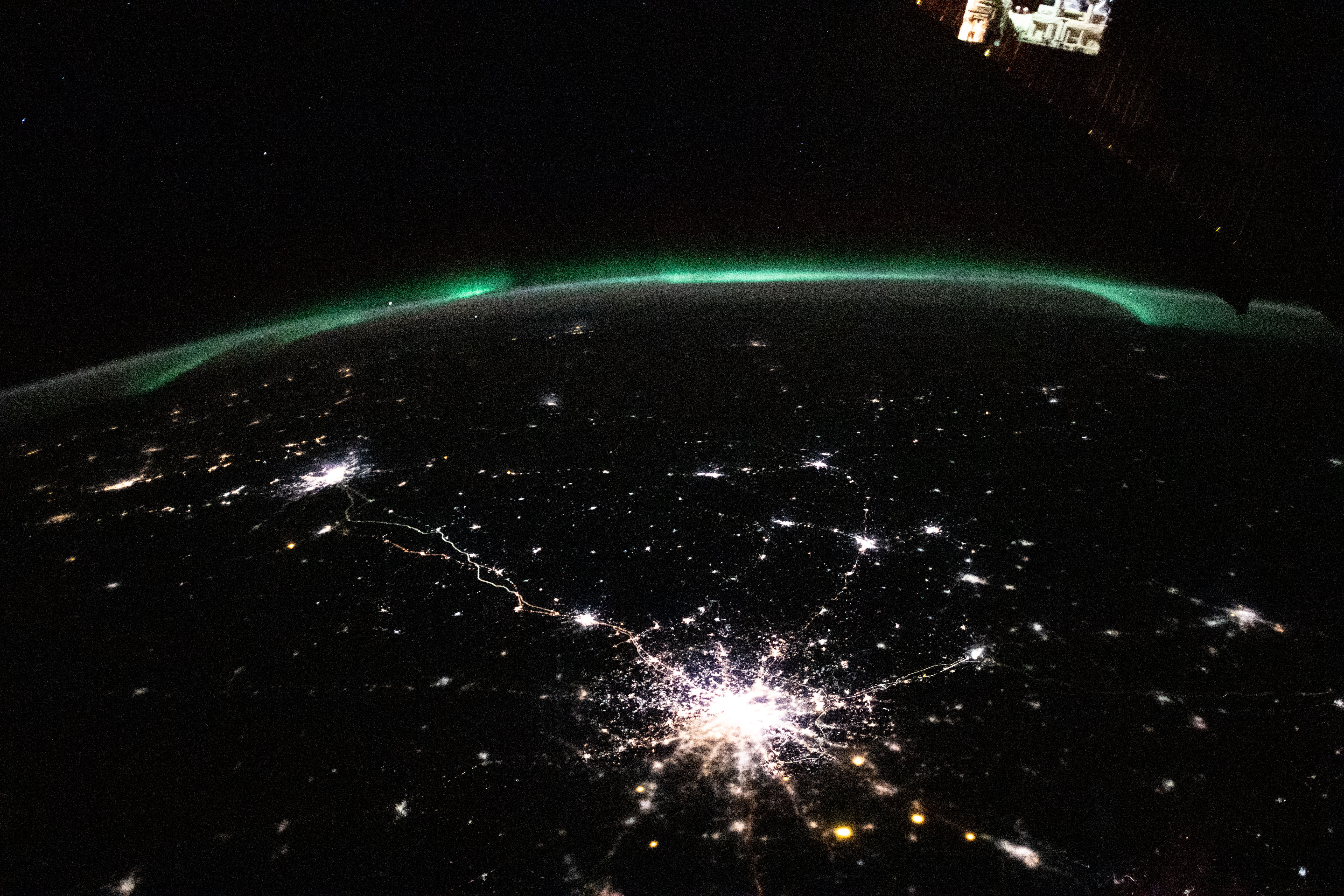 The city lights (bottom center to far left) of Moscow and Saint Petersburg in Russia, to Helsinki, Finland, are framed by an aurora in this photograph from the International Space Station as it orbited 264 miles above.