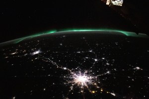 The city lights (bottom center to far left) of Moscow and Saint Petersburg in Russia, to Helsinki, Finland, are framed by an aurora in this photograph from the International Space Station as it orbited 264 miles above.