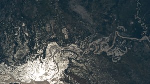 The sun's glint beams off the Paraguay River which separates a portion of the South American nations of Argentina and Paraguay in this photograph from the International Space Station as it orbited 265 miles above.