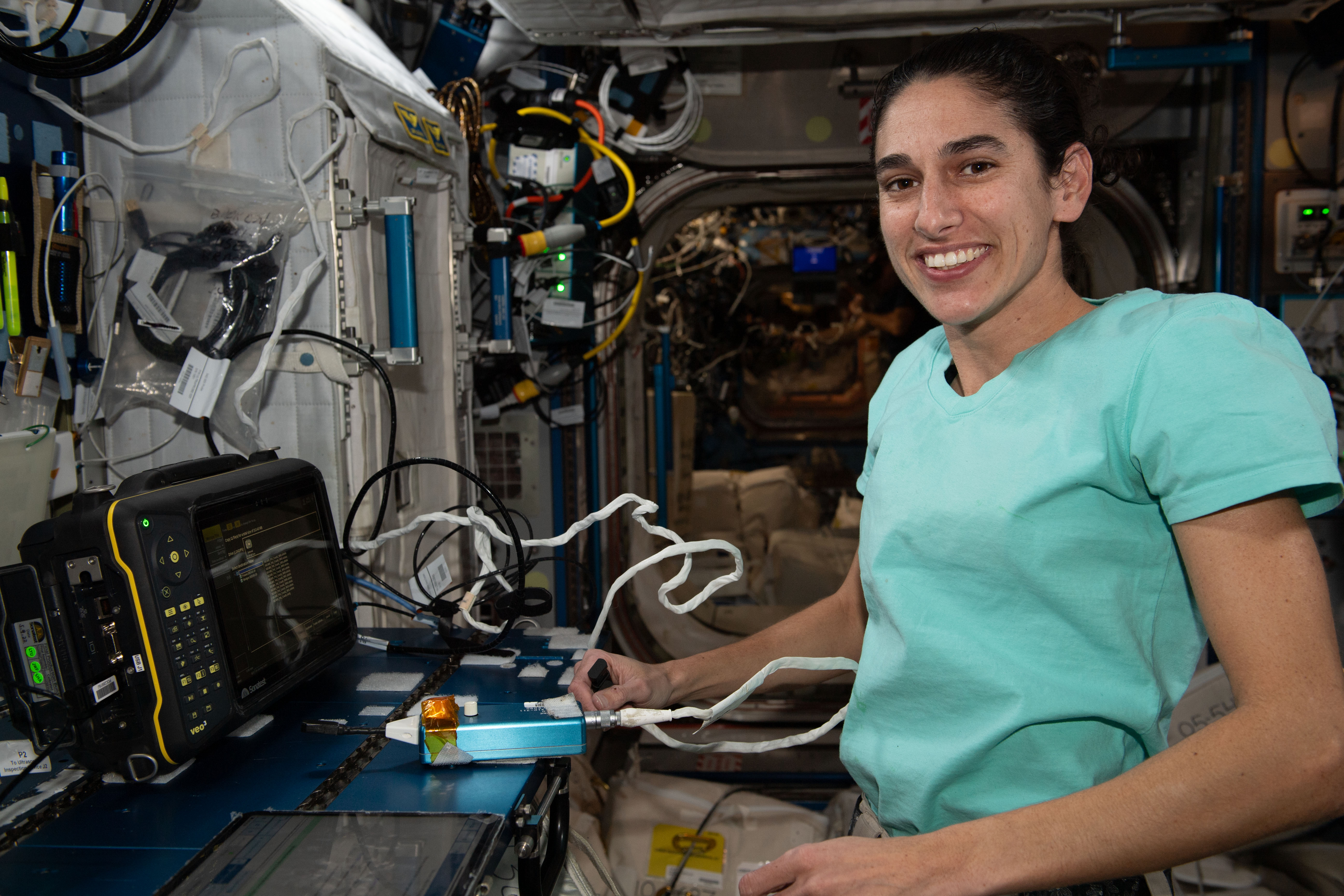 NASA astronaut and Expedition 70 Flight Engineer Jasmin Moghbeli works in the Harmony module and calibrates an ultrasonic inspection device that uses high-frequency sound waves to analyze materials aboard the International Space Station.