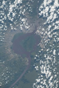 The Congo River encircles the island of Mbamu and splits two cities, both capitals of their respective nations. At left, Kinshasa represents the Democratic Republic of Congo, and at right, Brazzaville represents the Republic of Congo in this photograph from the International Space Station as it orbited 260 miles above the African continent.
