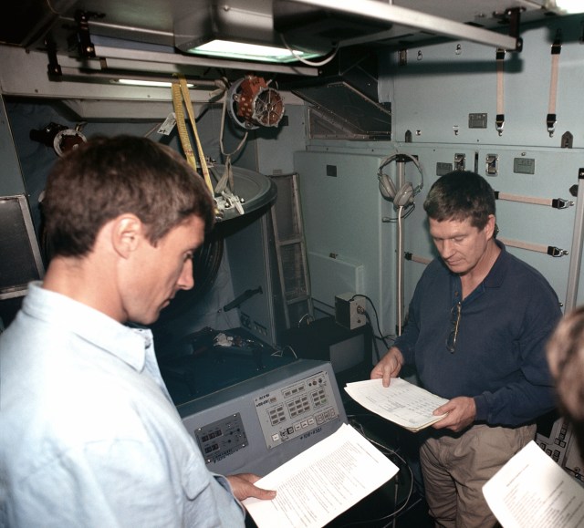 Astronaut William Shepherd (right) mission commander for ISS Expedition 1, and Sergei Krikalev, flight engineer, participate in a training session in a trainer/mockup of the Zvezda Service Module at the Gagarin Cosmonaut Training Center in Russia. Cosmonaut Yuri Gidzenko, Soyuz commander, is out of frame at right.