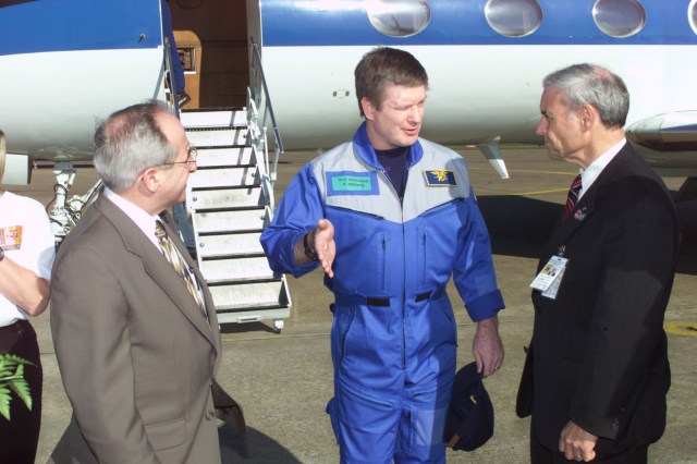 Astronaut William M. (Bill) Shepherd (center) talks with Joseph Rothenberg (left), NASA Associate Administrator for Space Flight, and Roy S. Estess, Acting Director of the Johnson Space Center (JSC), following crew arrival at Ellington Field, near JSC. Shepherd on March 21 completed a lengthy stay in Earth orbit, having served as commander for the ISS Expedition One mission.