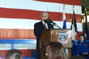 JSC Acting Director Roy S. Estess introduces the STS-102 and Expedition One crew members to a crowd gathered in Ellington Field's Hangar 990 during crew return ceremonies.