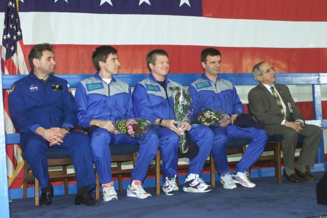 Members of the Expedition One crew await opportunities to individually address a crowd gathered at Ellington Field to honor their return to Houston. Pictured from the left are cosmonaut Vasily Tsibliev, Deputy Director of the Gagarin Cosmonaut Training Center in Star City; cosmonaut Sergei K. Krikalev, Expedition One flight engineer; astronaut William M. (Bill) Shepherd, mission commander; and Yuri P. Gidzenko, Soyuz commander; along with Joseph Rothenberg, NASA Associate Administrator for Space Flight.