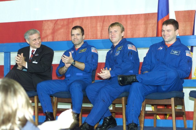 Applause was plentiful during the welcome home ceremonies for the joint crews of STS-102 and Expedition One. Pictured on the stage in Ellington Field's Hangar 990 are, from the left, JSC Acting Director Roy S. Estess, along with astronauts Paul W. Richards and Andrew S.W. Thomas, both STS-102 mission specialists, and James M. Kelly, pilot.