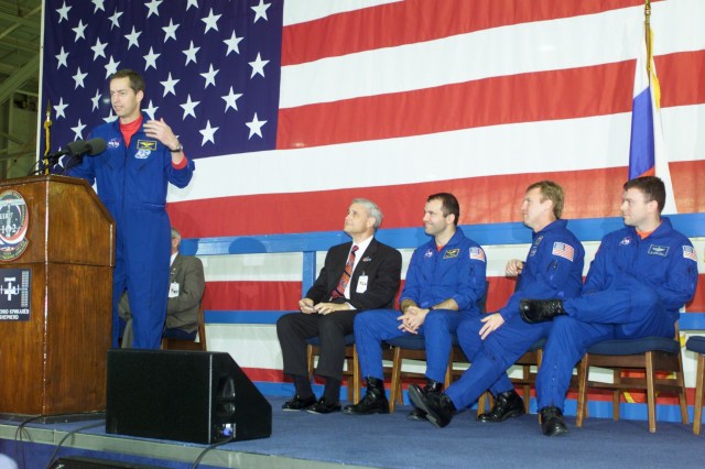 Astronaut James D. Wetherbee, STS-102 mission commander, speaks to a crowd of greeters during a crew return ceremony in Ellington Field's Hangar 990. Pictured in the background on the dais are (from the left) Roy S. Estess, Johnson Space Center's Acting Director; along with astronauts Paul W. Richards, Andrew S.W. Thomas and James M. Kelly of the STS-102 crew.