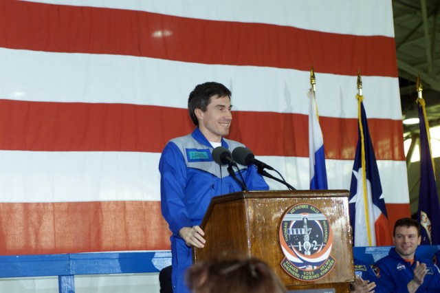 Cosmonaut Sergei K. Krikalev, Expedition One flight engineer, speaks to a crowd of greeters during a crew return ceremony in Ellington Field's Hangar 990. Pictured in the background on the dais is astronaut James M. Kelly, pilot.