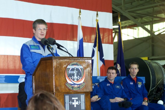 Astronaut William M. (Bill) Shepherd, Expedition One mission commander, speaks to a crowd of greeters during a crew return ceremony in Ellington Field's Hangar 990. Pictured in the background on the dais are astronauts James M. Kelly (left), STS-102 pilot, and James D. Wetherbee, commander.