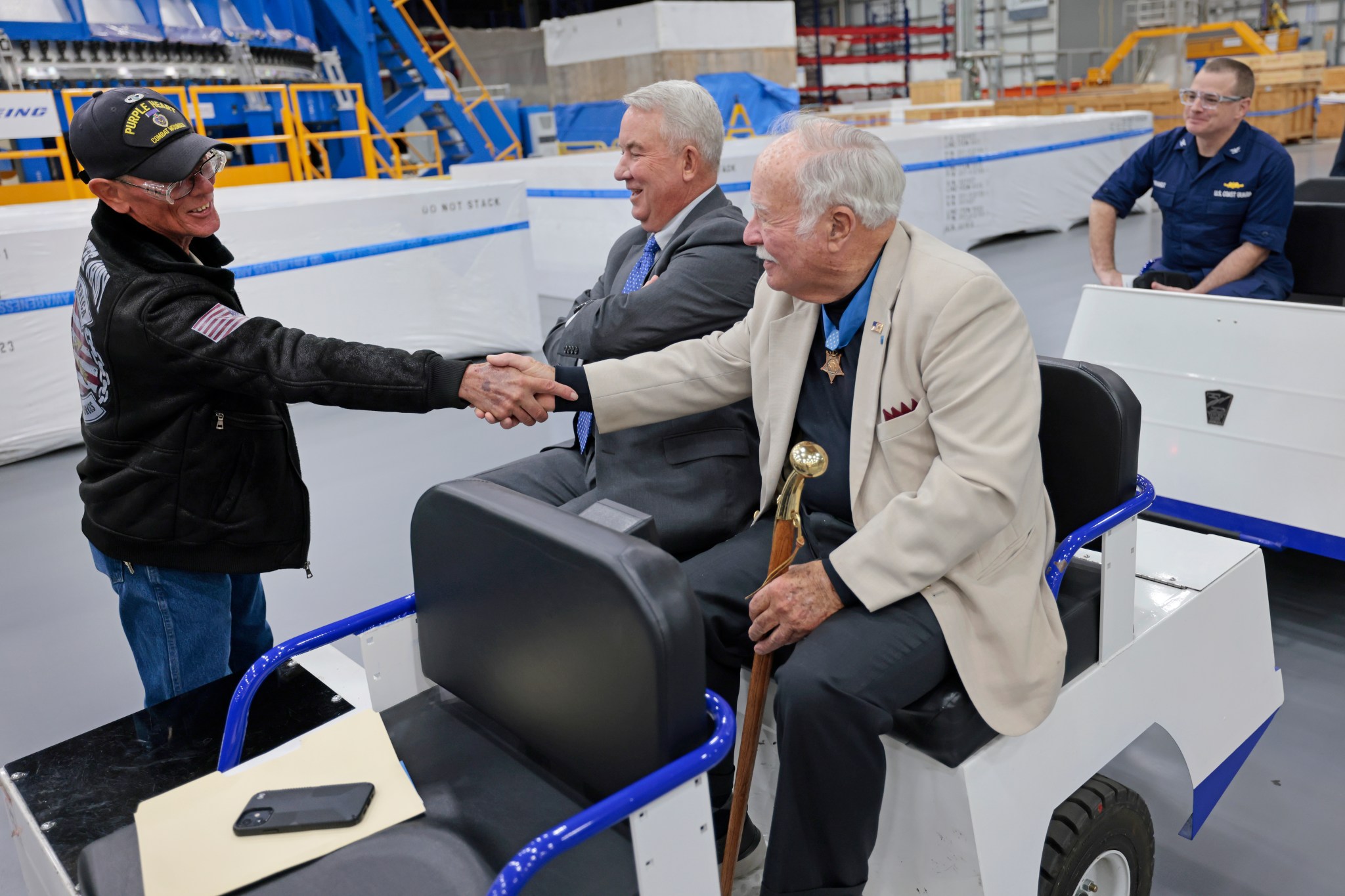 Freddie Grass, left, safety manager for Boasso Construction, visits with Mize and Barnum during a factory tour at Michoud. Grass has four Purple Hearts, while Mize has the Distinguished Superior Service Medal.