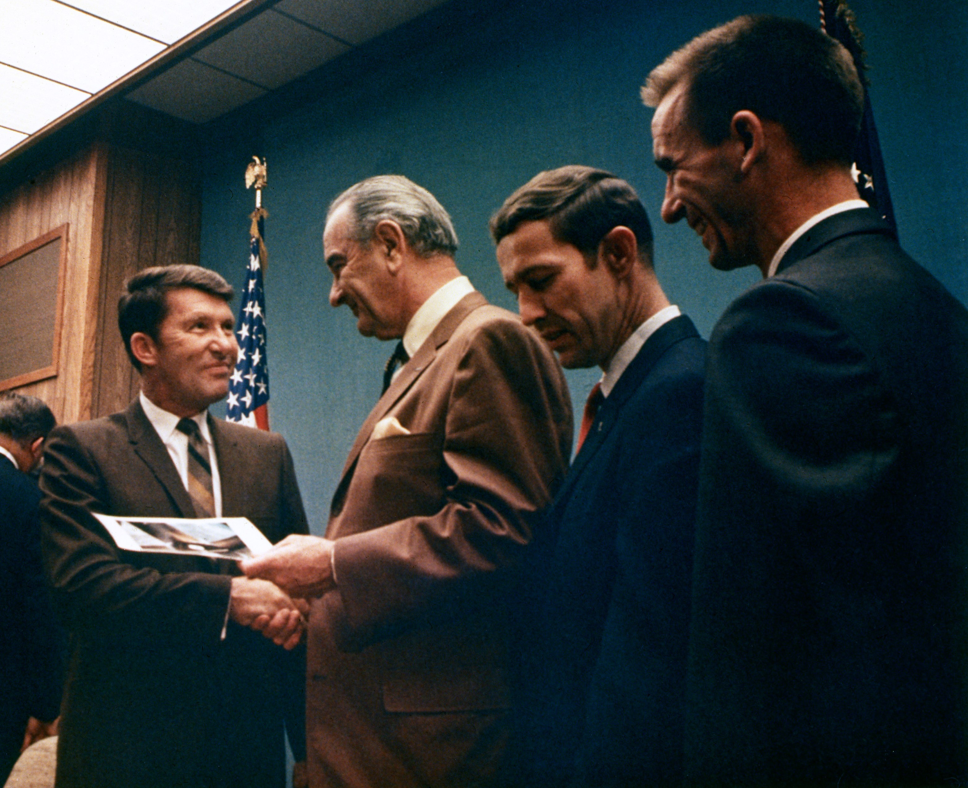 Image of President Lyndon B. Johnson, second from left, presents Apollo 7 astronauts Walter M. Schirra, left, Donn F. Eisele, and R. Walter Cunningham with Exceptional Service Medals at the LBJ Ranch