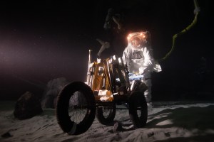 NASA spacesuit engineer Scott Wray pushing a tool cart during a simulated moonwalk underwater at NASA Johnson Space Center's Neutral Buoyancy Laboratory.